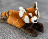 Side view of 17-inch weighted red panda stuffed animal showing fluffy tail and soft paws.