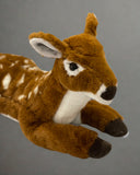 Close-up of weighted fawn plush head with soft ears and white facial markings.
