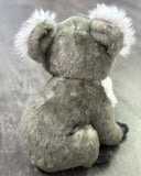Back/three-quarter view of weighted koala plush showing plush gray coat and rounded body; compact 12-inch size.