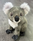 Front view of 12-inch weighted koala plush with fluffy white ears and soft gray fur; calming stuffed animal up to 4 lbs.