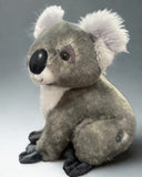 Side profile of weighted koala plush sitting; friendly face, velvety gray fur and white chest; up to 4 lbs with glass microbeads.