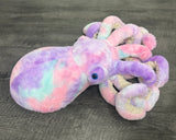 Side view of tie-dye purple pink blue weighted octopus with textured spring-back tentacles