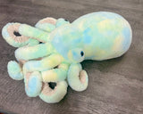Side view of seafoam weighted octopus showing plush head and bouncy tentacles
