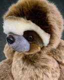 Close-up of weighted sloth plush face; ultra-soft brown and cream fur with gentle eyes; 21-inch calming stuffed animal.