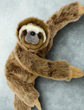 Side angle of 21-inch weighted sloth showing fluffy body and long arms; cozy calming plush.