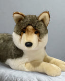 Jumbo lifelike weighted wolf plush, gray and tan, laying pose—close-up of face and front paws.