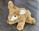 Three-quarter view of super-soft 13-inch weighted fawn plush in a low, cuddly pose.