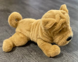 5-inch weighted Shar Pei plush with tan coat and curled tail, laying on gray surface.