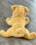 Shar Pei plush from behind showing curled tail and soft wrinkles.