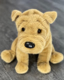 Weighted Shar Pei plush—soft tan fur with puppy folds, sitting pose on gray surface.