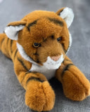 Close-up of weighted tiger plush face with soft fur, white cheeks, and golden eyes; cuddly 19-inch laying tiger.
