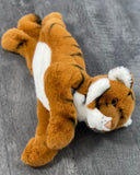 Top/side view of 19-inch weighted tiger plush lying down; orange coat with black stripes and white belly; calming