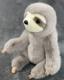 Three-quarter close view of 16-inch super-soft sloth plush sitting; smooth fur, cream muzzle, and plush limbs weighted for even pressure.