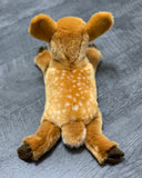 Top-down view of 15-inch weighted fawn plush displaying gentle, low-profile pose.