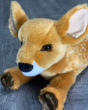 Close-up of weighted deer plush face with dark eyes and soft nose.