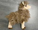 Upright side profile of 15-inch weighted llama plush with shaggy tan fleece, long lashes on a gray background.
