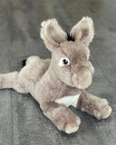 Front three-quarter view of 18-inch weighted donkey; relaxed paws forward, soft white belly panel.