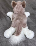Back view of weighted husky stuffed animal with fluffy tail and soft plush coat in gray and white.
