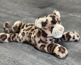 Three-quarter view of 20-inch weighted leopard plush lying down; silky tan coat with dark rosette spots; fixed 4-lb calming stuffed animal.