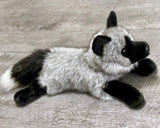 Side view of 19-inch weighted gray fox stuffed animal showing fluffy tail and relaxed body.