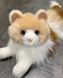 Close-up of weighted Ragdoll cat plush with soft muzzle and bright eyes.