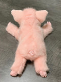 Back view of pink pig plush showing curled tail and plush coat; floppy 17-inch weighted toy.