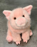 Front sitting view of pink pig plush with smiling snout and perky ears; ultra-soft weighted stuffed animal.
