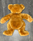 Oversized ultra-plush weighted teddy bear lying flat to show open-style body for larger weighted surface area.