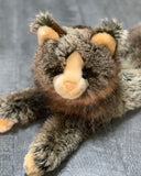 Lifelike weighted Maine Coon cat plush, close-up of face with tufted ears and long mottled fur, 20-inch lounging pose.