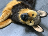 Close-up of Weighted German Shepherd plush lying on side, soft faux fur, realistic eyes and shiny nose in focus, 40" up to 24lbs.