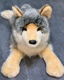 Front view of weighted wolf stuffed animal with outstretched paws, lifelike faux-fur texture.