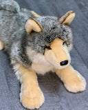 Ultra-plush weighted wolf in relaxed three-quarter pose, realistic grey coat and cream legs.