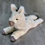 Three-quarter view of 19-inch weighted zebra plush lying down; baby-soft striped coat with tufted mane and tail; calming stuffed animal.
