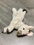 Overhead angle of zebra plush reclined with legs out; fluffy striped fur and tufted tail; calming weighted companion.
