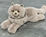 Gray Persian cat weighted plush lying down, round face with amber eyes and ultra-soft fur.