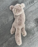 Top view of 17-inch gray weighted Persian cat plush with long tail in prone, slightly curved posture.