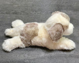 Side view of weighted Great Pyrenees plush showing soft patches and long floppy legs