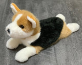 19" White, tan, and black tri-color corgi weighted stuffed animal in laying position on gray background.