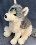 Seated three-quarter portrait of 18-inch weighted gray wolf plush with perky ears and bushy tail, realistic soft fur for sensory input.