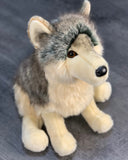 Seated portrait of 18-inch weighted gray wolf plush with perky ears and lifelike fur.