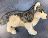 Side profile of weighted wolf plush in a standing pose showing gray and cream faux fur.