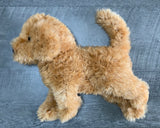 Tan labradoodle plush shown from the side to display full 15-inch length and curved tail.