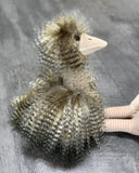 Side view of plush ostrich with brown-cream faux-feather plumage and soft striped legs, weighted 19-inch cuddle toy.