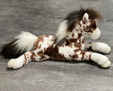Side profile of a baby-soft weighted appaloosa horse plush in white with brown spots, 22 inches long calming companion.