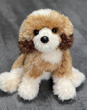 15-inch weighted Goldendoodle plush with fluffy cream-gold coat, sitting on gray wood surface