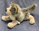 Laying side view pose of weighted wolf plush with raised tail and forward paws; ultra-soft 15-inch, long realistic fur in gray brown and beige.