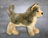 Side profile of weighted wolf plush standing to show full body and tail; soft gray and tan coat.