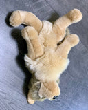 Top-down view of 15-inch weighted wolf plush lying on its back with fluffy faux fur and floppy legs; compact calming stuffed animal.