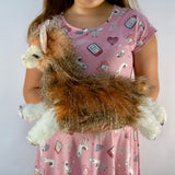 Child holding weighted llama plush to show 18-inch size and fluffy texture.