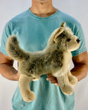 Person holding the weighted wolf plush to show 15-inch scale; cozy, cuddly sensory companion.